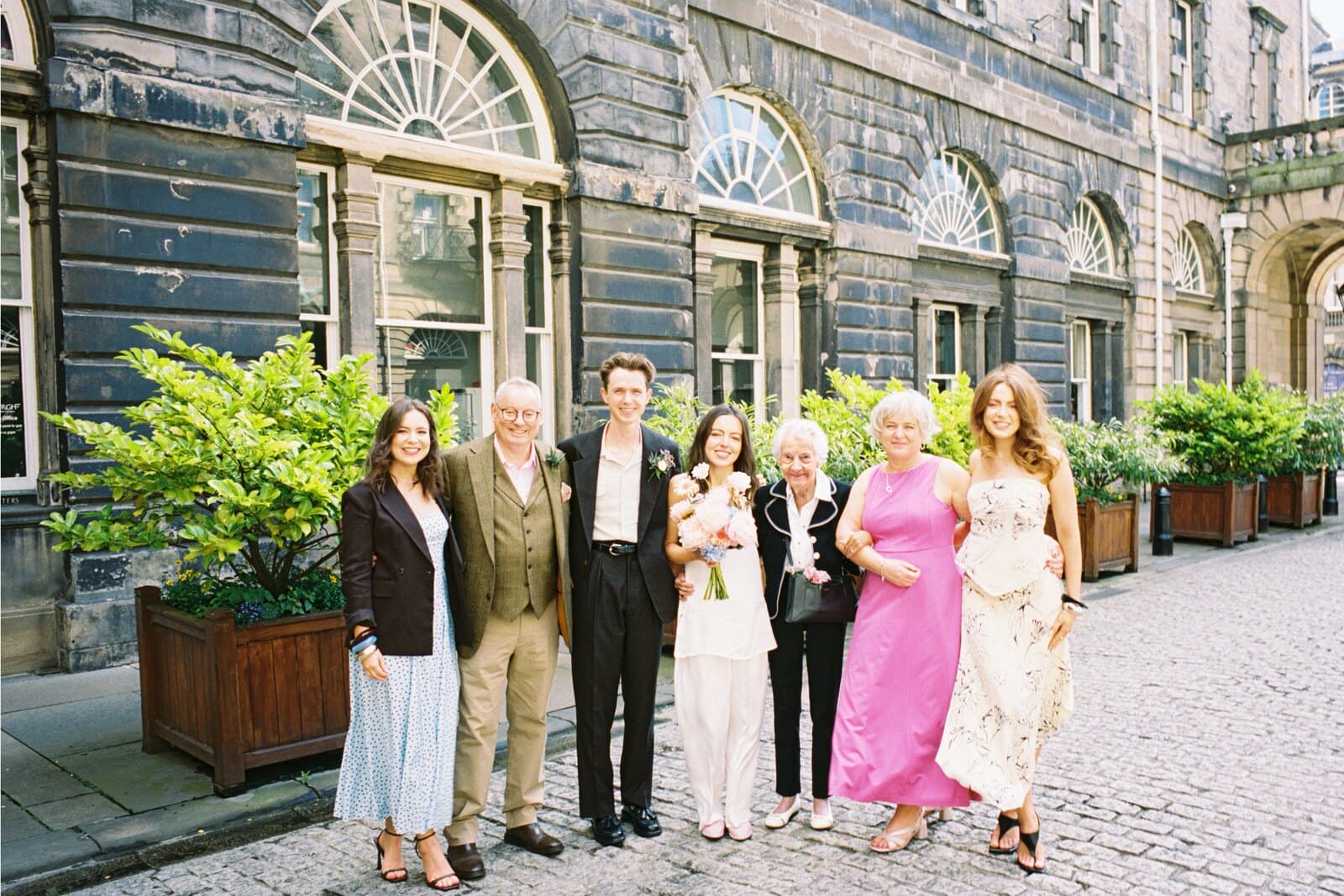 Becca and Rory with family outside the registry office