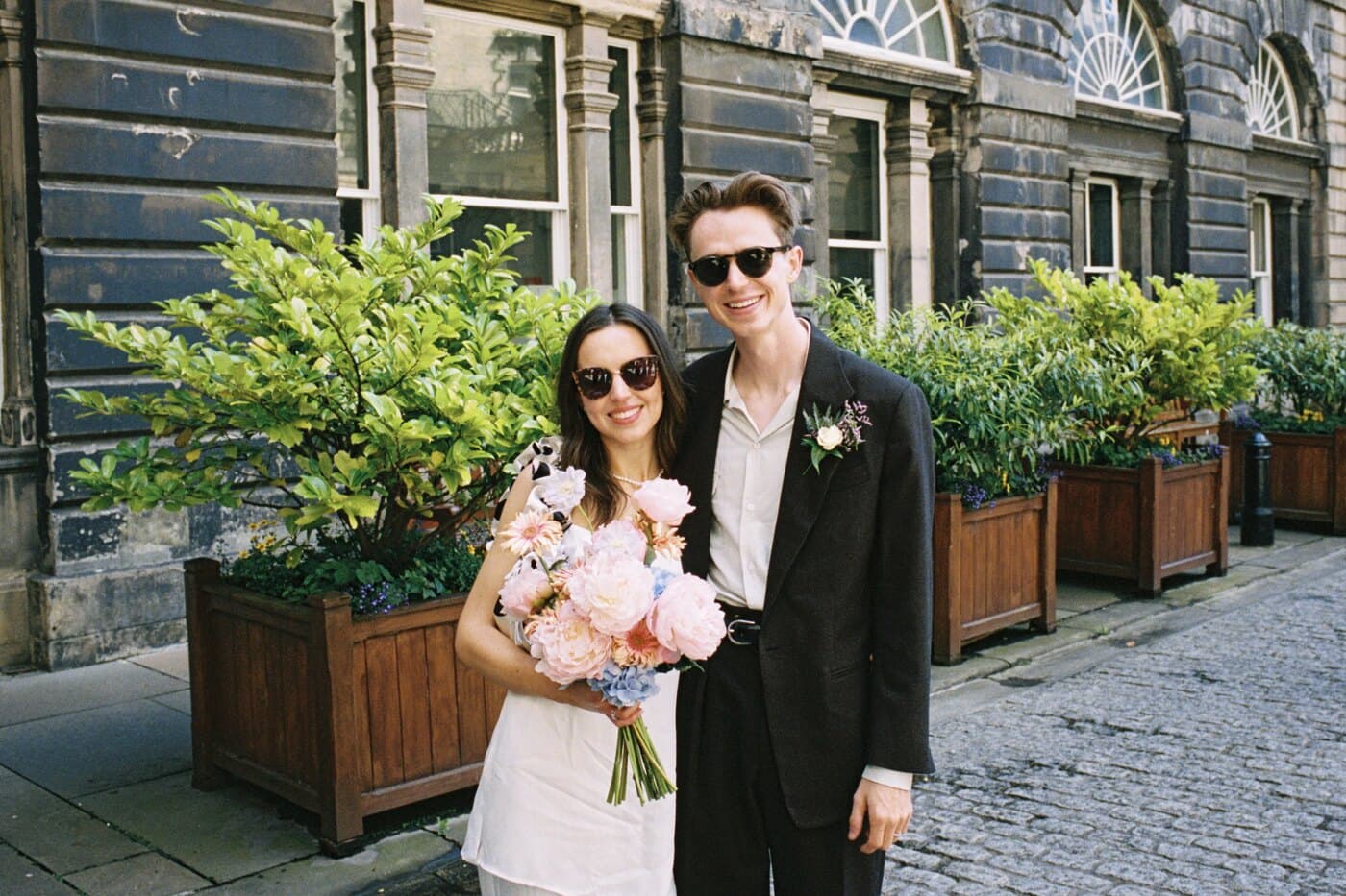 Becca and Rory wearing sunglasses on their wedding day