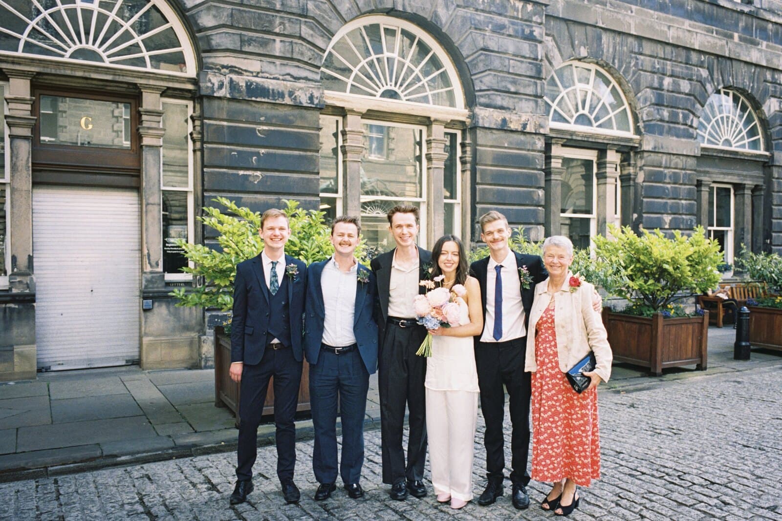 Becca and Rory with wedding guests outside Edinburgh Registry Office