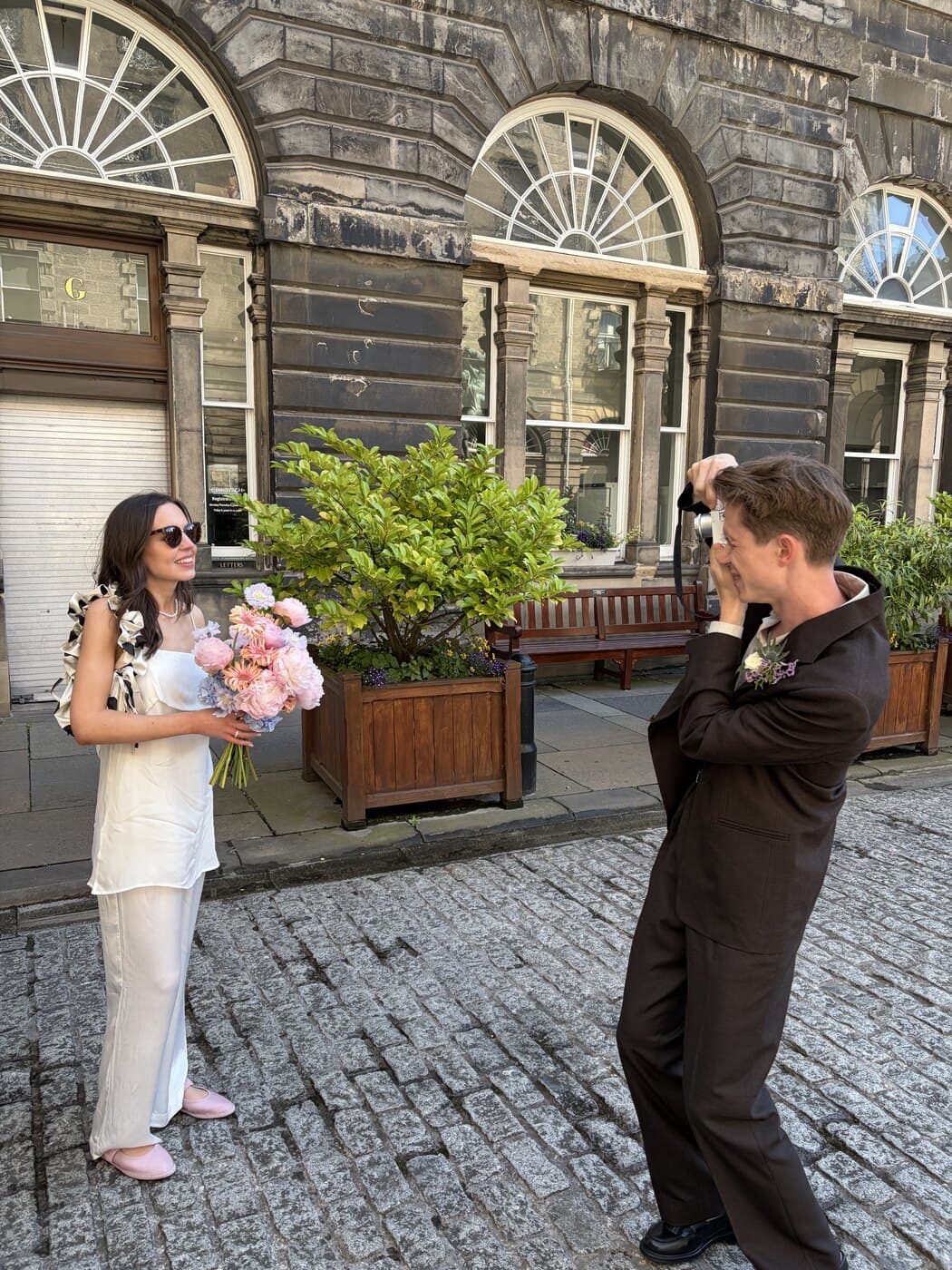 Becca holding flowers outside Edinburgh Registry Office